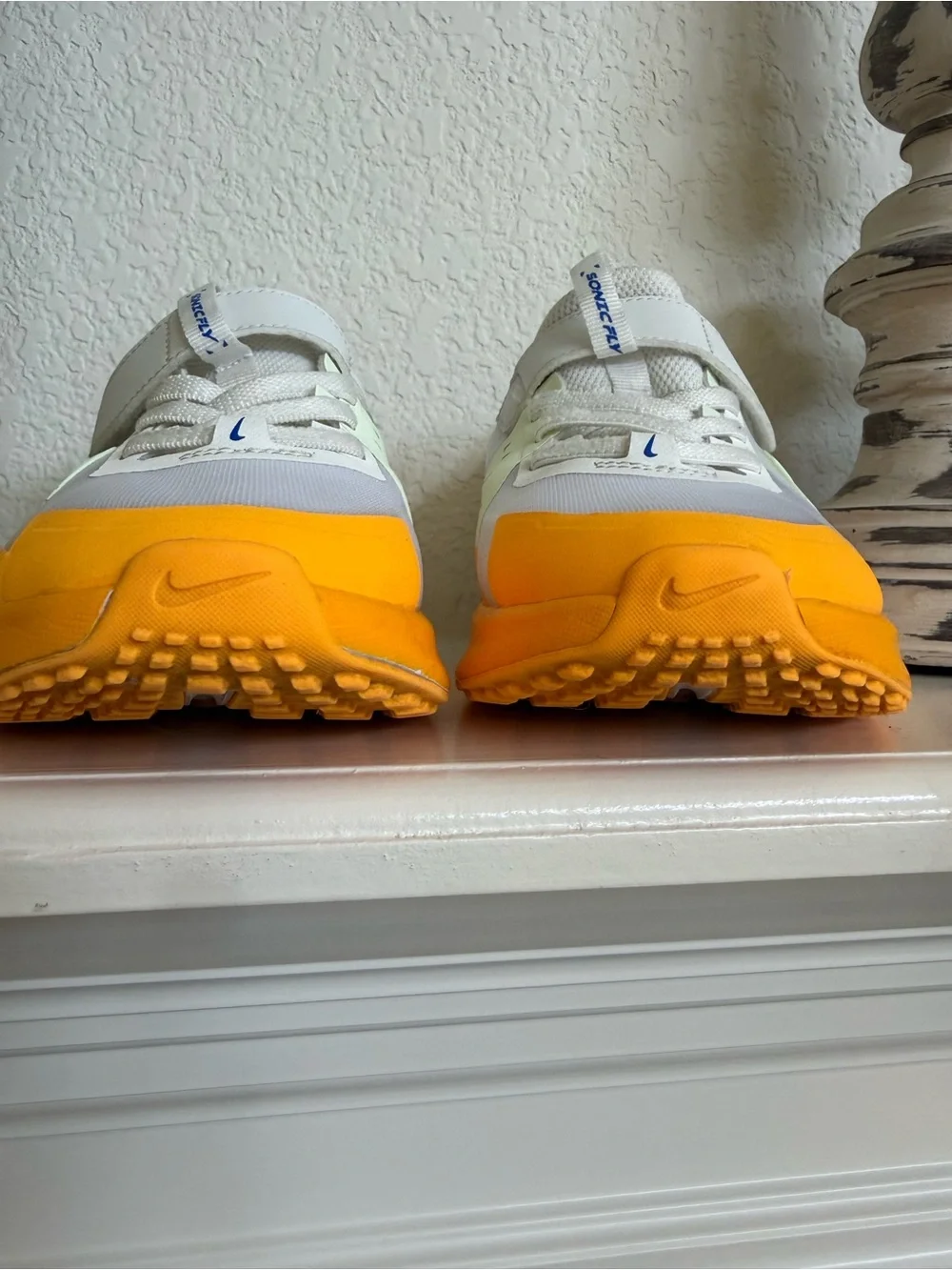 Nike Kids White Sneakers with Orange Toe and Blue Accents